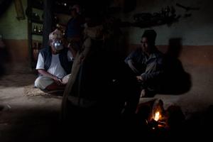 Ritual specialists taking a rest inside a house after the bali or jalim puja