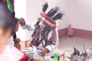 The official ritual specialist or shaman of the Kirat Rai Yayokkha giving tikka (blessing) at sakela puja