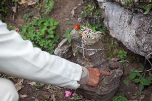 Bishnu Bahadur Chamling explaining the reijakhule stones near the place of worship for Khema