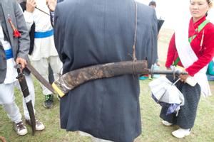 Participant of the Tuwachung-Jayajum festival wearing a sword at the back
