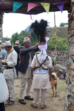 The ritual specialist in charge of the bhume ritual at Tuwachung-Jayajum festival is assisted with fixing his turban
