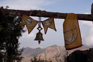 Flag of the Kirat Rai Yayokkha and bell at the place of worship for Toma at Tuwachung-Jayajum hill