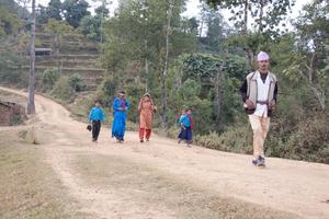 Villagers walking by while the founding session of the Tomakhema and Kakcilipu society is being held