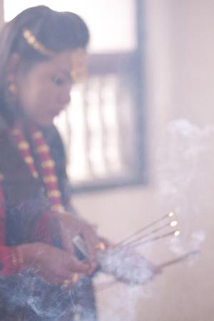 Limbu participant placing offerings for the sakela puja at Hattiban temple