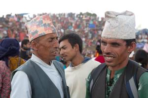 Two men discussing during the Tuwachung-Jayajum festival, crowd of people