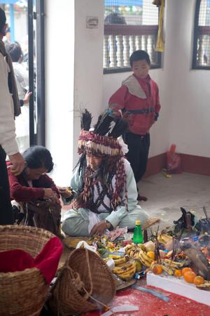 The official ritual specialist or shaman of the Kirat Rai Yayokkha giving tikka (blessing) at sakela puja