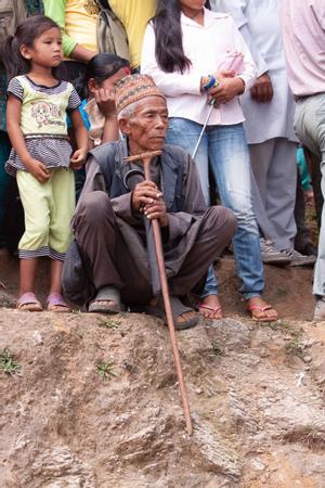 Portrait of an elder male participant at Tuwachung-Jayajum festival, surrounded by other participants