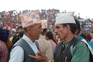 Two men discussing during the Tuwachung-Jayajum festival, crowd of people