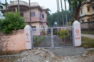 Symbol of the new religious movement "Heavenly Path" on walls and (gate) pillars in Dharan