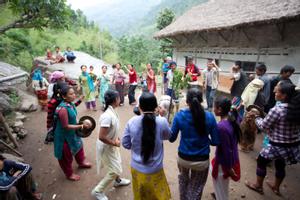 Villagers dancing sakela in the courtyard of a house after the rituals at the bhume or sakela than