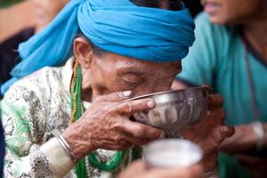 Participant at the sakela or bhume puja drinking rice beer