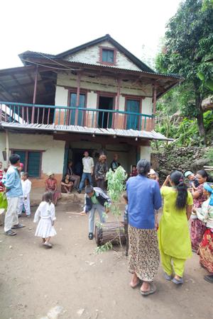 Villagers dancing in the courtyard during sakea puja