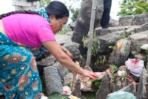 A woman giving offerings at the place of worship for Khema at Tuwachung-Jayajum festival