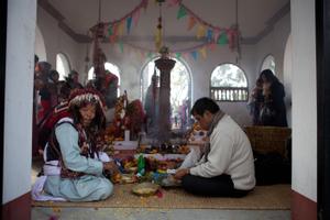 The official ritual specialist or shaman of the Kirat Rai Yayokkha with a participant during sakela puja
