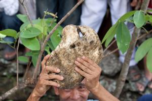 A ritual assistant presents the sakela stones